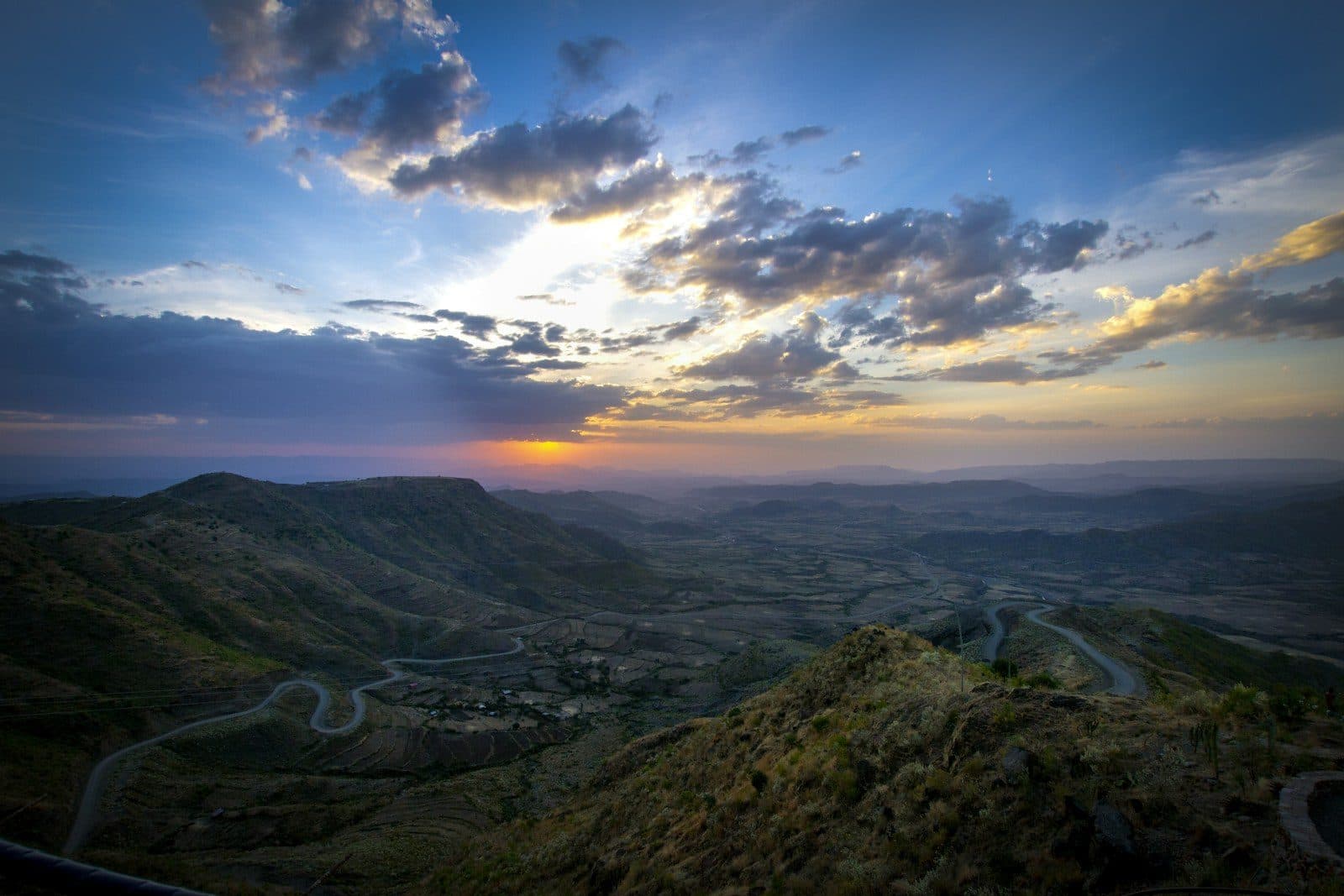 Sunset over the Ethiopian highlands with a road winding through