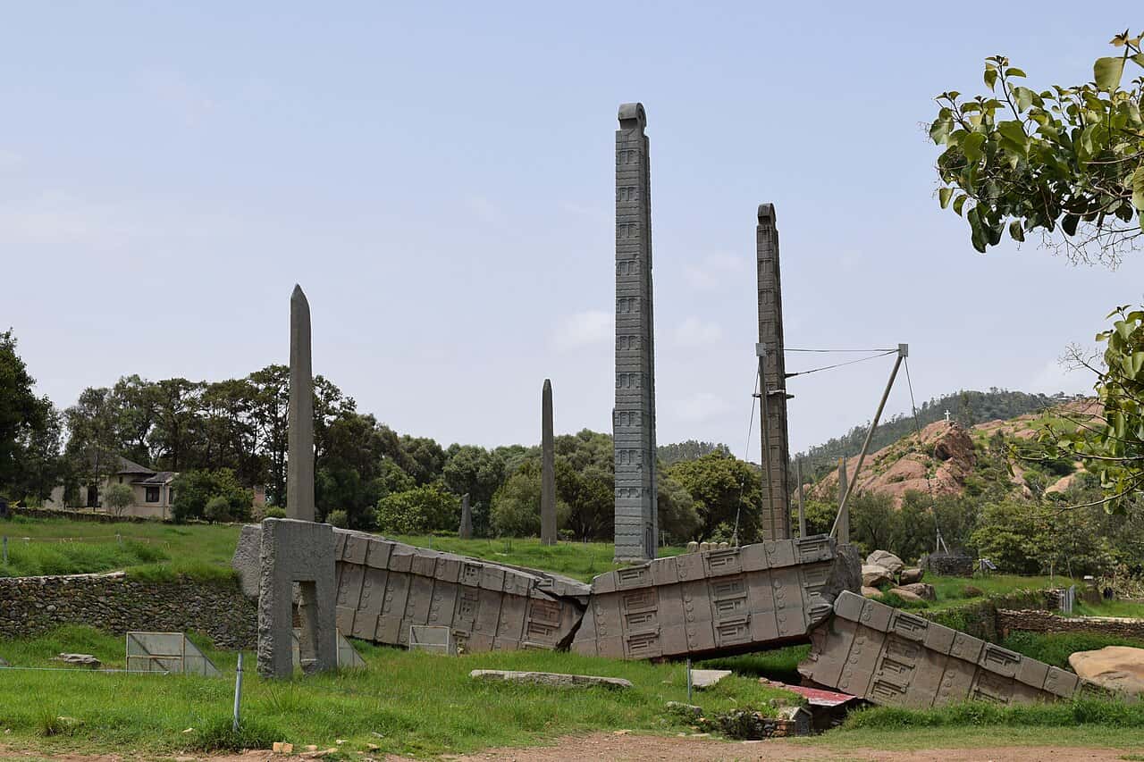 Broken sections of a fallen stele in front of standing stelae, Northern Stelae Park, Aksum